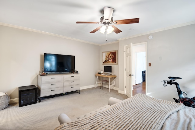 carpeted bedroom with baseboards, ornamental molding, and a ceiling fan