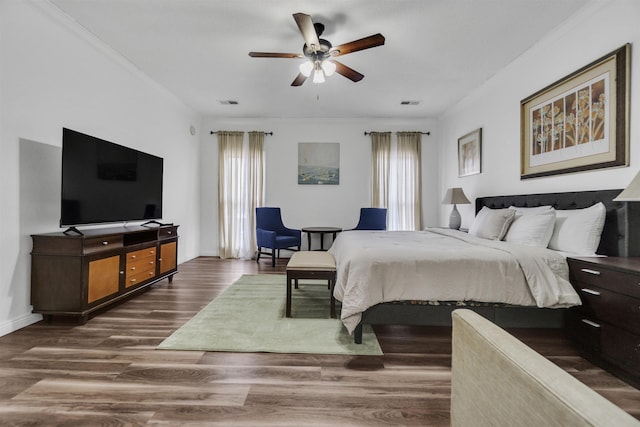 bedroom with visible vents, ceiling fan, baseboards, and wood finished floors