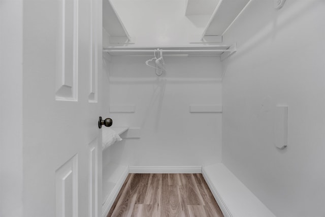 spacious closet with wood finished floors