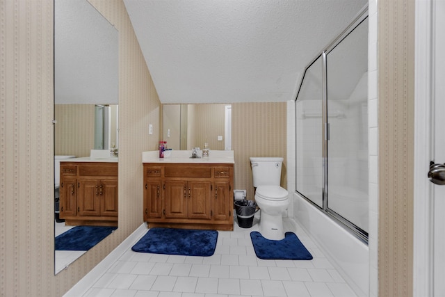 full bathroom featuring toilet, combined bath / shower with glass door, vanity, a textured ceiling, and wallpapered walls