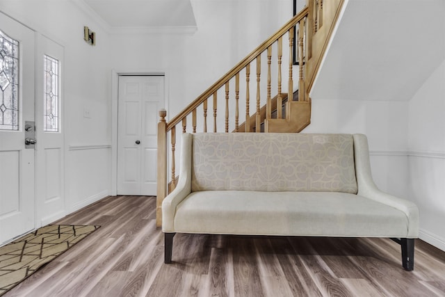 entryway with baseboards, stairs, ornamental molding, and wood finished floors