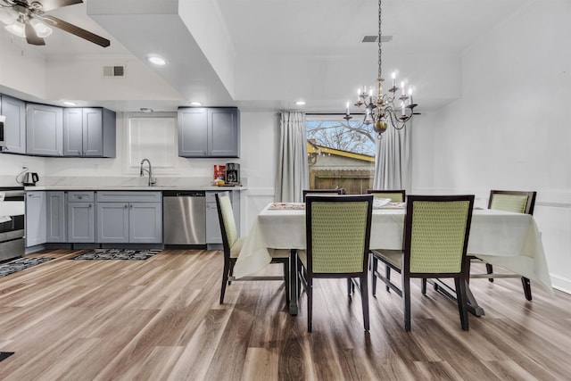 dining room with light wood-style floors, visible vents, a ceiling fan, and recessed lighting