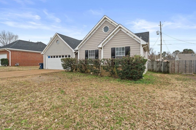 ranch-style house with a garage, fence, concrete driveway, and a front yard