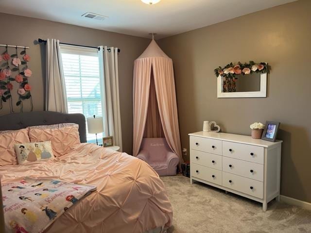 bedroom with visible vents, light carpet, and baseboards