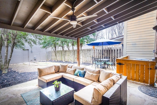 view of patio with a ceiling fan, outdoor dining space, outdoor lounge area, and fence