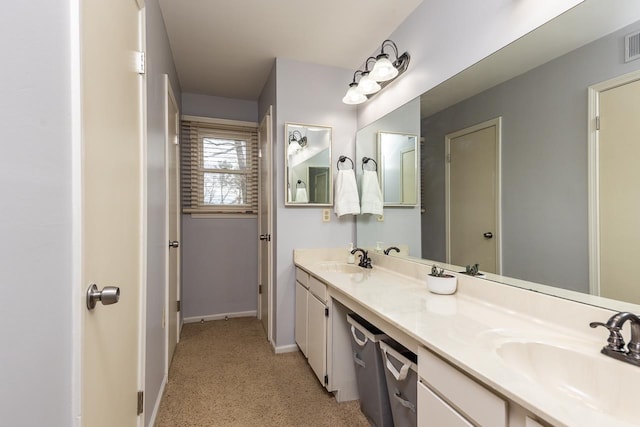 full bathroom with visible vents, a sink, baseboards, and double vanity