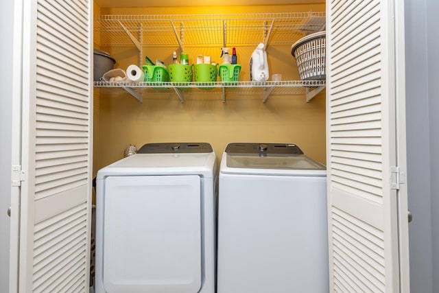 clothes washing area featuring laundry area and washing machine and clothes dryer