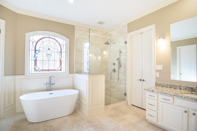 full bathroom featuring visible vents, ornamental molding, a stall shower, wainscoting, and a freestanding tub