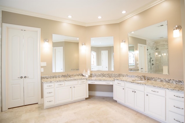 bathroom featuring a shower stall, crown molding, two vanities, and a sink