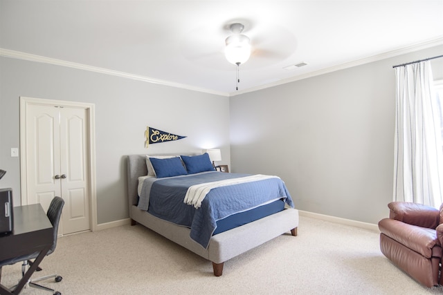 carpeted bedroom featuring ceiling fan, ornamental molding, visible vents, and baseboards