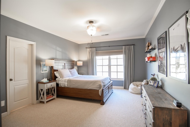 carpeted bedroom featuring a ceiling fan, visible vents, and crown molding