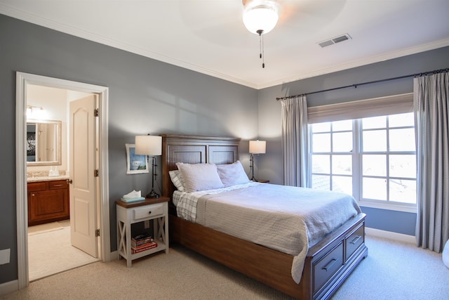 bedroom with light colored carpet, visible vents, ensuite bathroom, ornamental molding, and baseboards