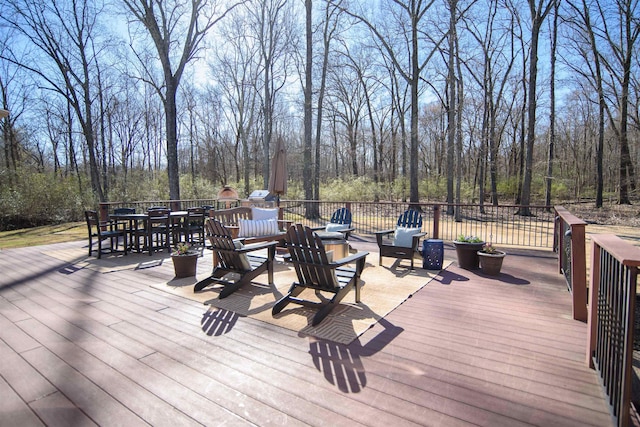 wooden terrace featuring outdoor dining space