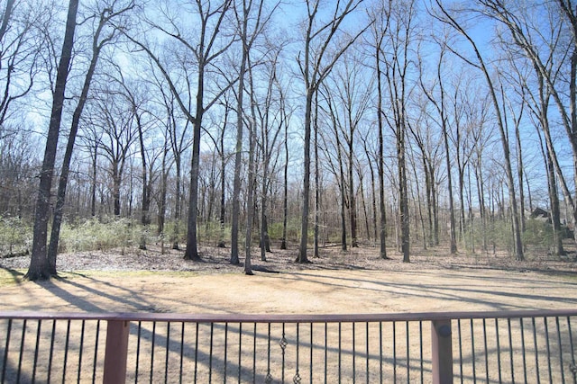 view of yard with fence and a view of trees