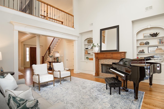 sitting room featuring built in features, visible vents, and wood finished floors