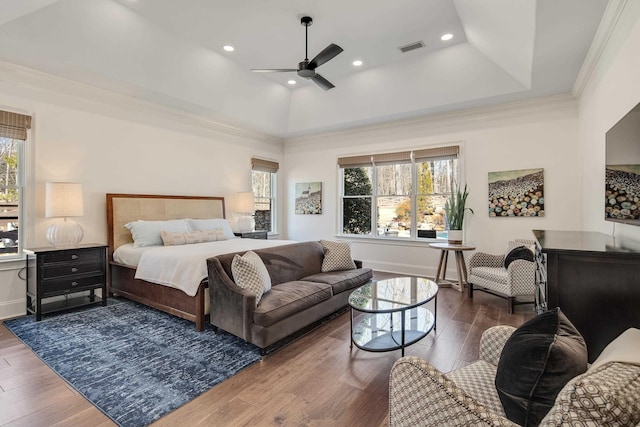 bedroom featuring hardwood / wood-style floors, multiple windows, and visible vents