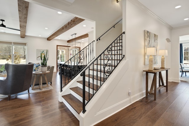 stairs with beam ceiling, a healthy amount of sunlight, and hardwood / wood-style flooring