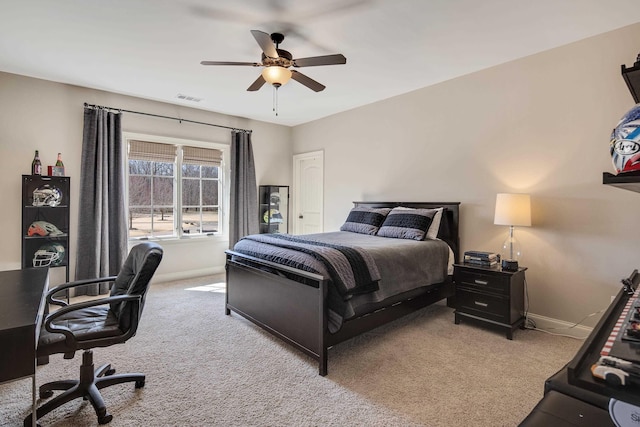 bedroom featuring light carpet, baseboards, visible vents, and a ceiling fan