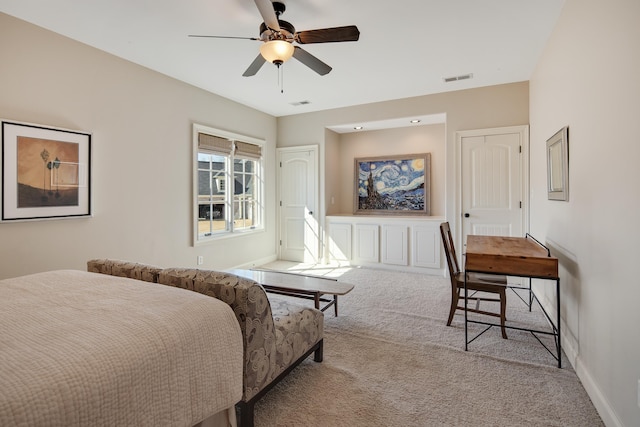 carpeted bedroom with visible vents, ceiling fan, and baseboards