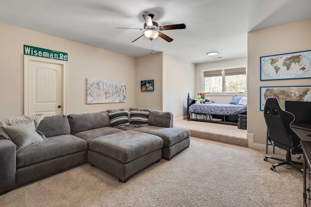 living area with carpet, visible vents, ceiling fan, and baseboards