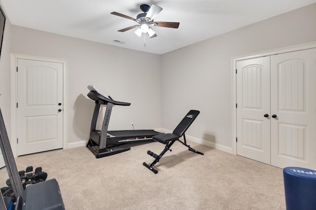 exercise area featuring carpet floors, visible vents, baseboards, and a ceiling fan