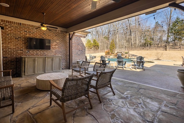 view of patio with a ceiling fan and fence