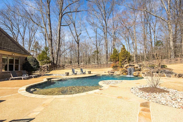 outdoor pool featuring a patio area and a fenced backyard