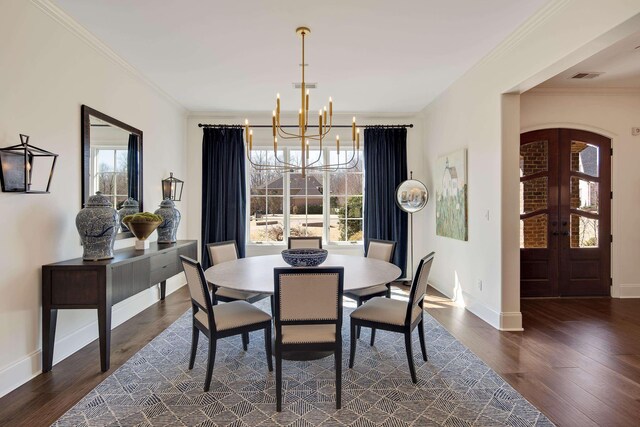 dining space with arched walkways, french doors, dark wood finished floors, and crown molding