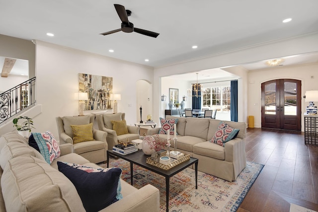 living room featuring arched walkways, hardwood / wood-style floors, stairs, french doors, and recessed lighting