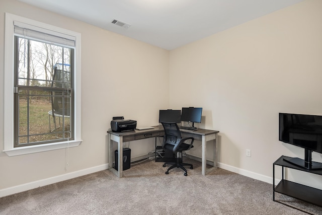 carpeted home office with visible vents and baseboards