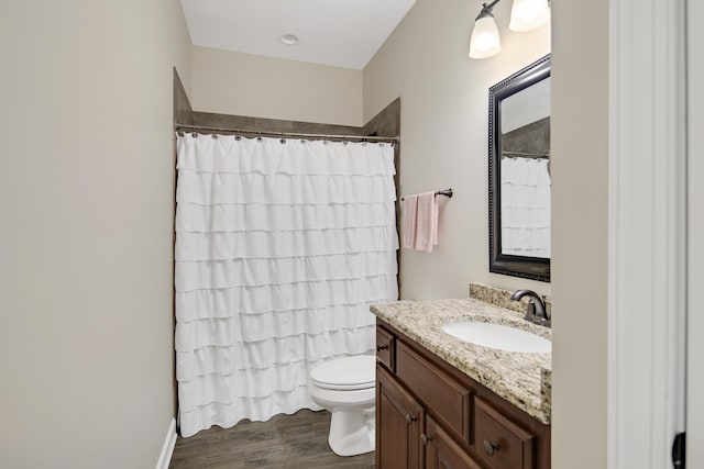 full bathroom with toilet, curtained shower, wood finished floors, and vanity