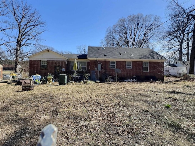 back of house with fence and brick siding