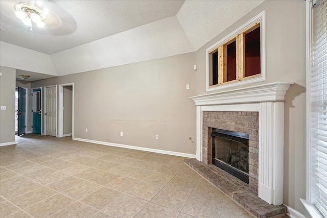 unfurnished living room featuring lofted ceiling, a fireplace, baseboards, and light tile patterned floors