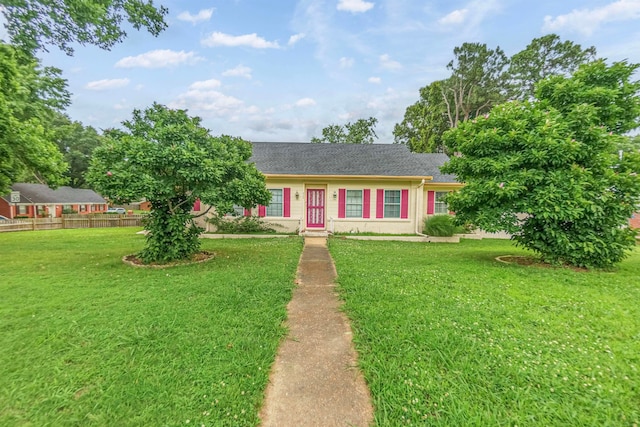 view of front of home with fence and a front lawn