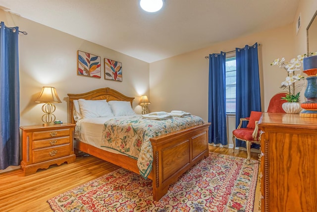 bedroom featuring light wood-style flooring and visible vents