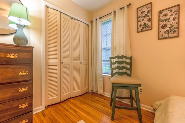 sitting room featuring baseboards and wood finished floors