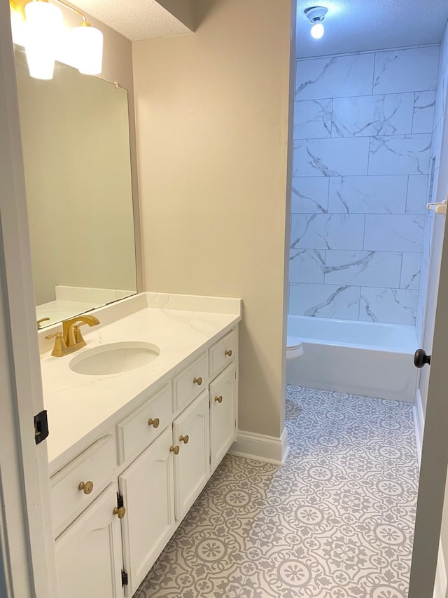 bathroom with baseboards, toilet, tile patterned floors, a textured ceiling, and vanity