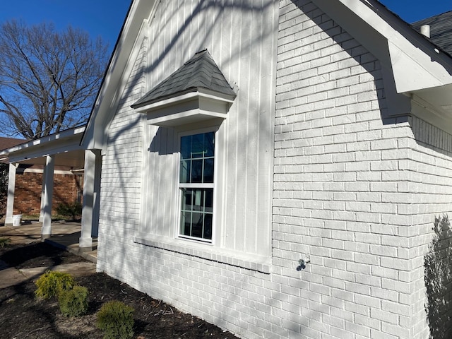 view of property exterior featuring brick siding