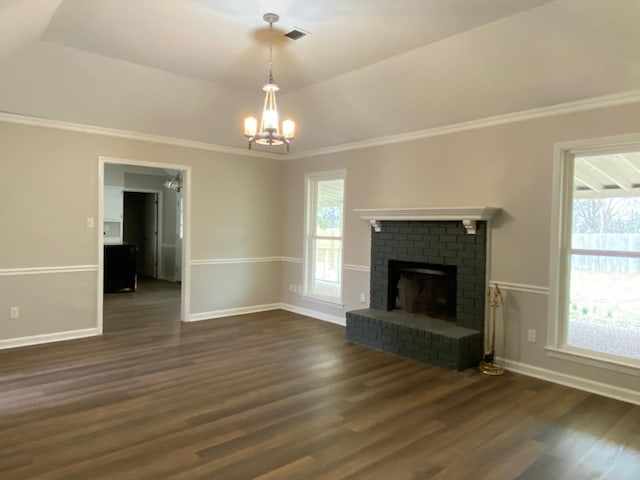 unfurnished living room featuring dark wood-style floors, a healthy amount of sunlight, visible vents, and a fireplace