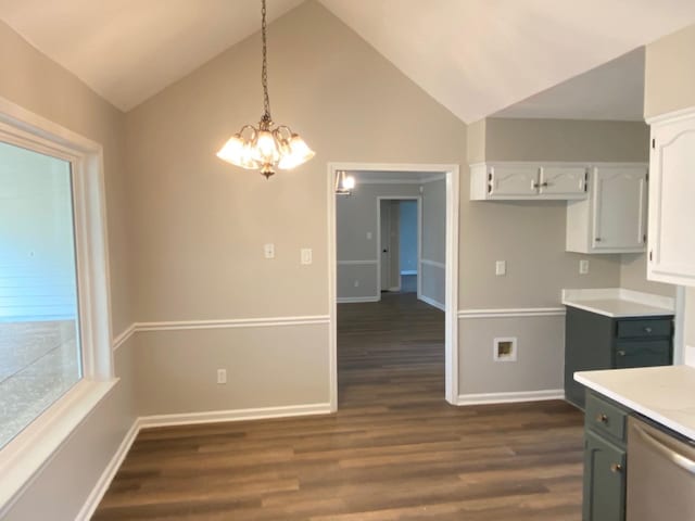 kitchen featuring baseboards, light countertops, hanging light fixtures, dishwasher, and dark wood finished floors