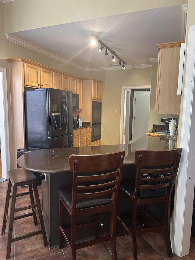 kitchen with light brown cabinets, a breakfast bar, a sink, black appliances, and crown molding