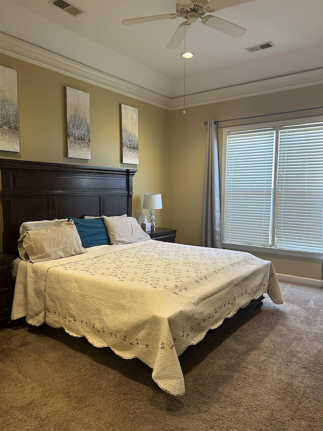 bedroom with ceiling fan, ornamental molding, carpet, and visible vents