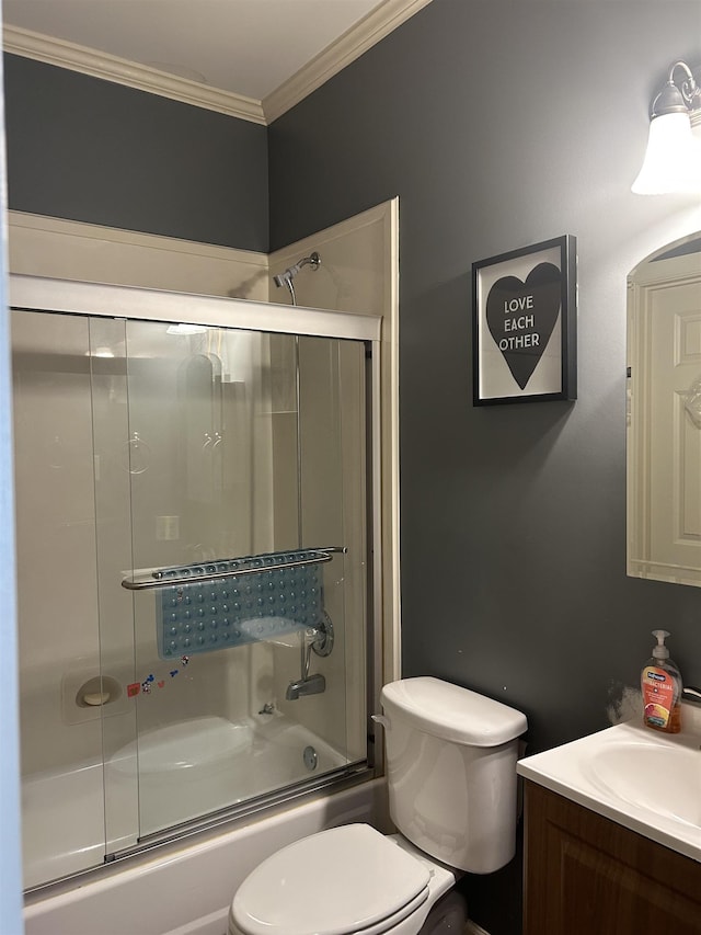 bathroom featuring ornamental molding, enclosed tub / shower combo, vanity, and toilet