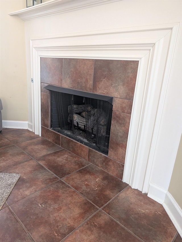 details with baseboards and a tile fireplace