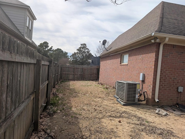 view of yard featuring a fenced backyard and central AC unit