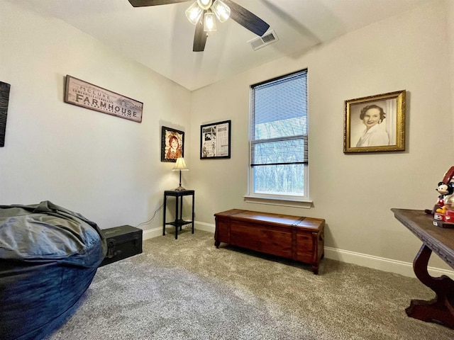 living area with ceiling fan, carpet, visible vents, and baseboards