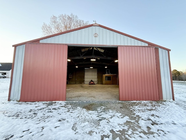 snow covered structure with a pole building and an outdoor structure