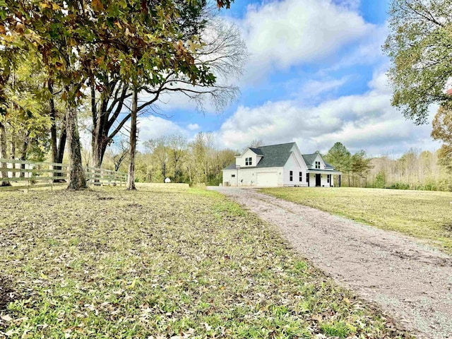 view of yard featuring fence and driveway