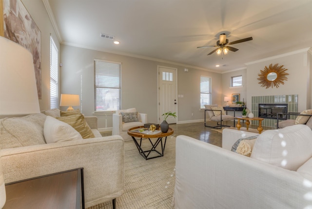 living area with a healthy amount of sunlight, visible vents, and ornamental molding