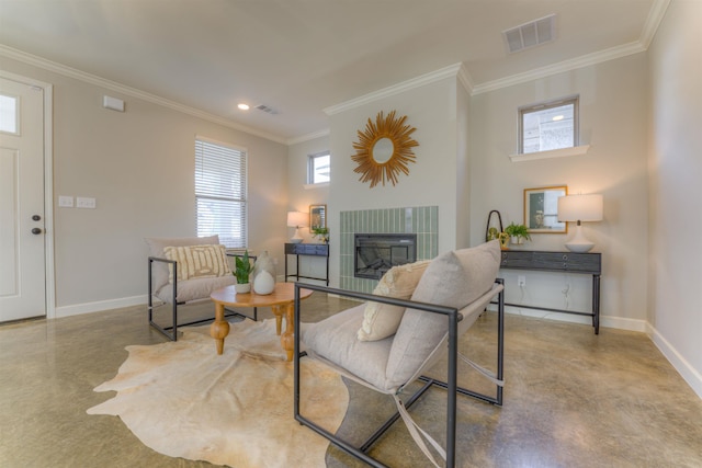 living room featuring ornamental molding, visible vents, a fireplace, and baseboards